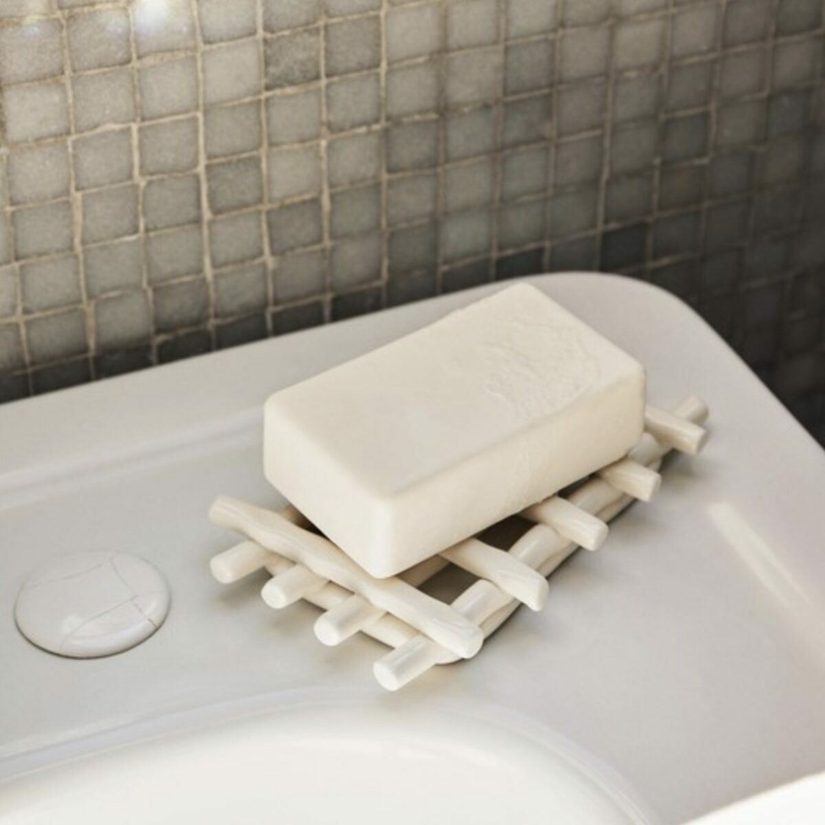 Porte-savon rectangulaire en céramique blanche Ferm Living tressé à la main avec fentes d'égouttement.