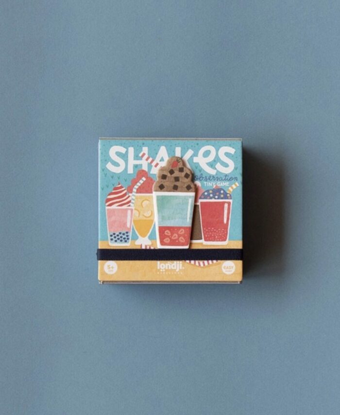 Étale des composants du jeu Gelato : tuiles circulaires illustrées de glaces, jetons en bois et cartes de jeu.