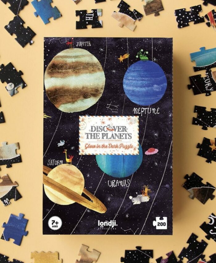 Boîte rectangulaire du puzzle Discover the Planets de Londji montrant une illustration du système solaire et la mention "Glow in the dark".